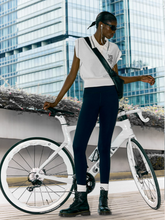a lady wears a beige polo shirt with black leggins